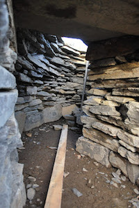 The inside of a passageway of reconstructed broch replica, with dry stone walling construction.