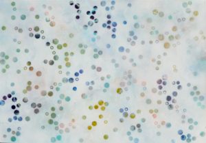A landscape oriented canvas with mottled whit ground with small scale dots of different sizes scattered around the space, in navy blue and soft ochre yellow, pale blues, greens, greys and pale pinks.